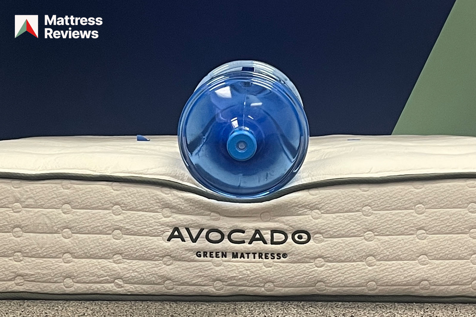 Photo of a water jug sitting on the edge of the Avocado Green mattress to demonstrate edge support