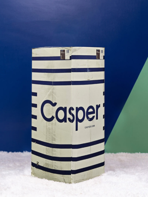 A photo of the Casper mattress box sitting in a bedroom. 