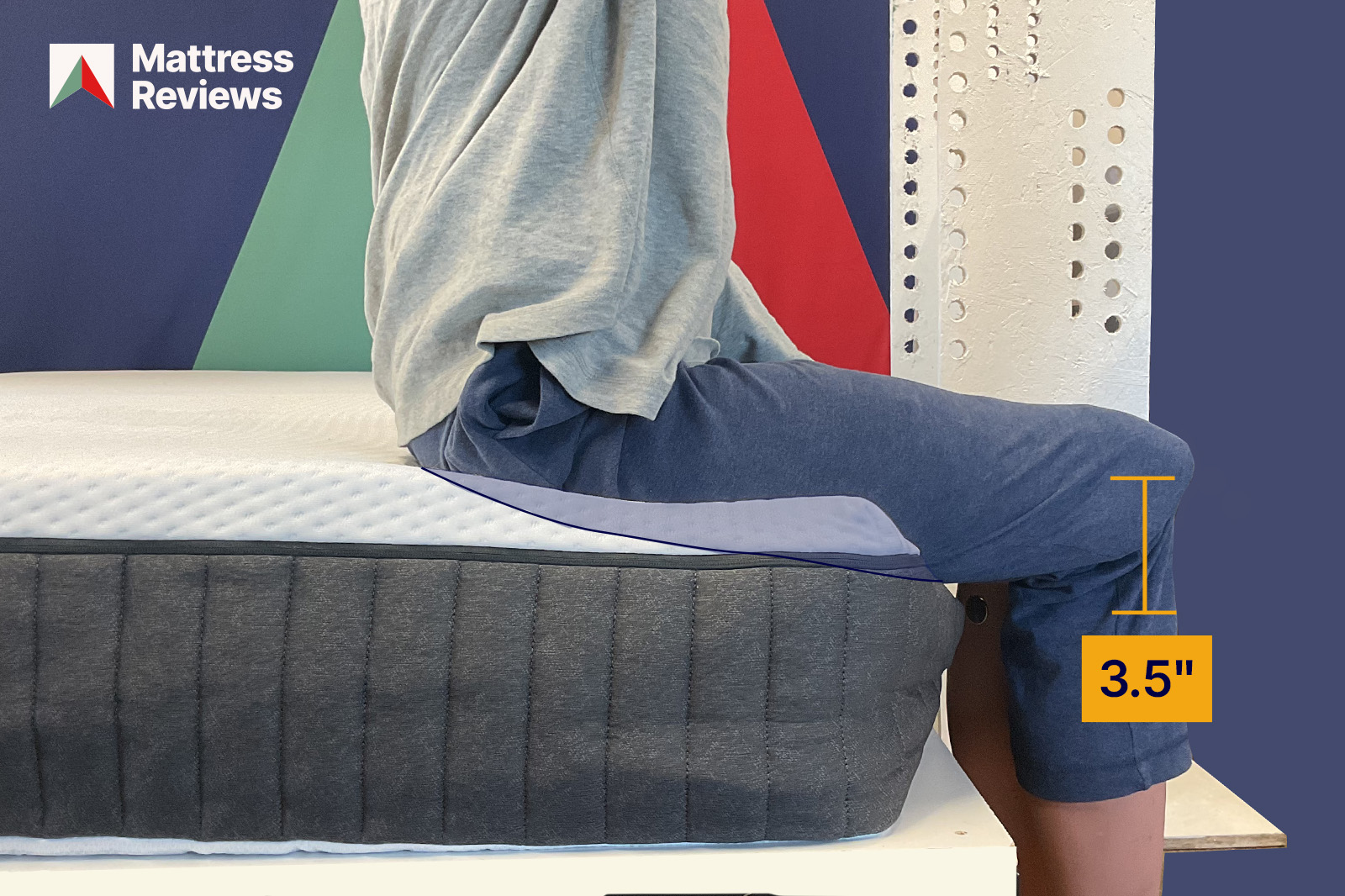 photo of a mannequin sitting on the edge of the emma orignal mattress with 35