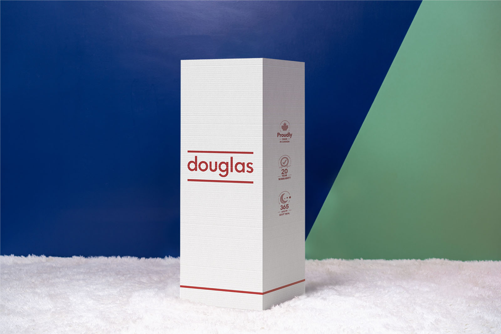 Photo of the Douglas Original Mattress box on the floor in a bedroom taken from a front angle.