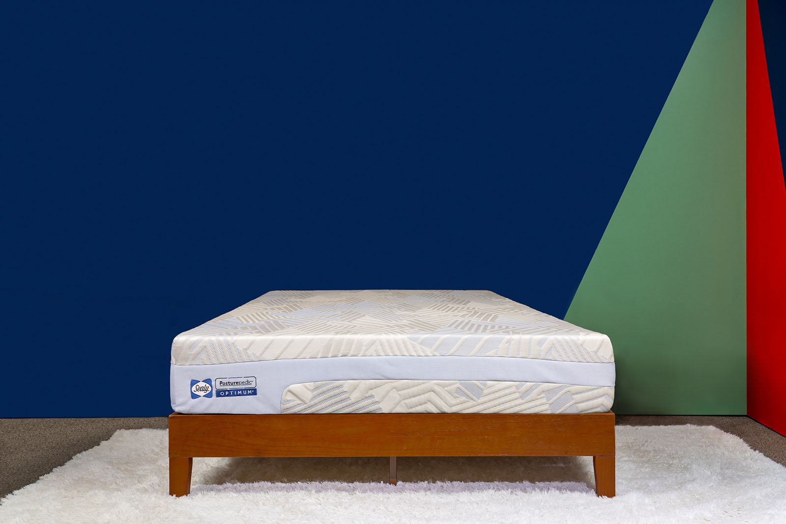 photo of the Sealy Posturepedic Optimum Chill Trio Dione mattress on a bed frame in a bedroom