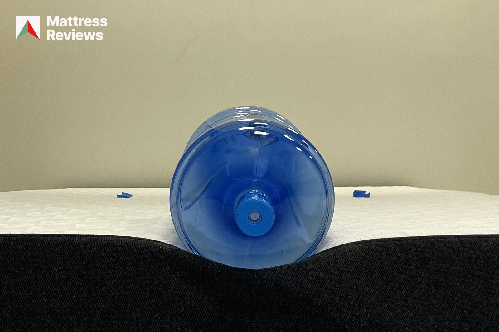 photo of a water bottle lying on the edge of a Cocoon by Sealy mattress to demonstrate edge support