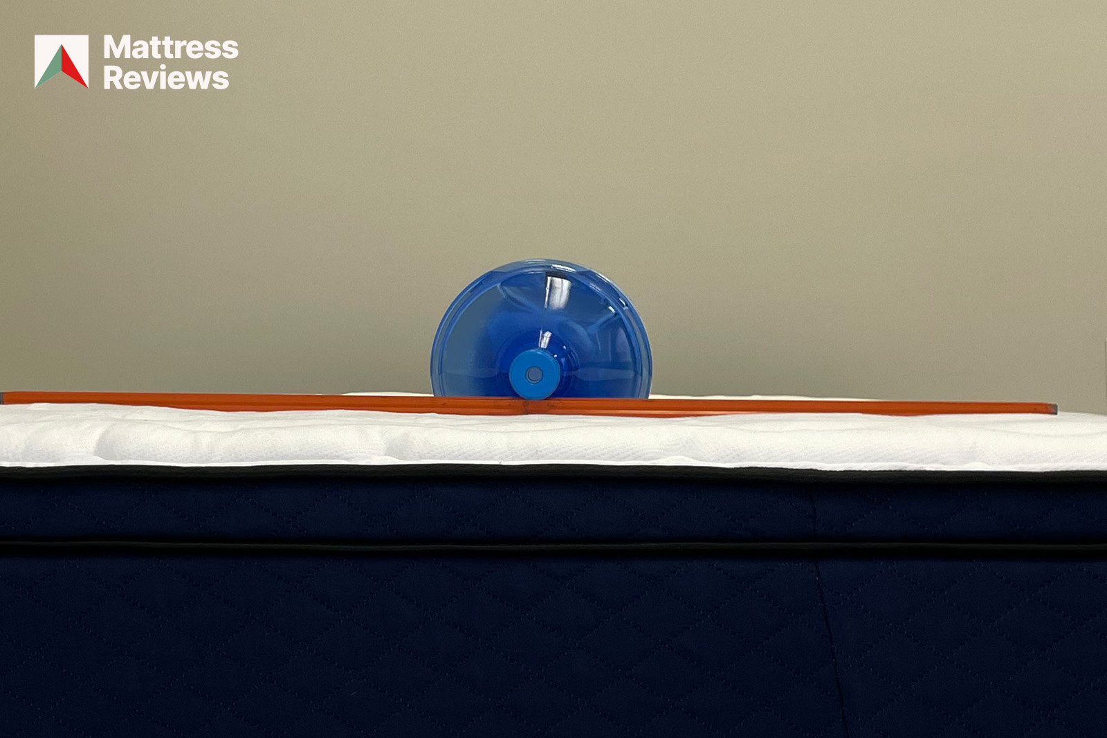 Image of a water jug on the S&S hybrid mattress with a level to indicate mattress firmness