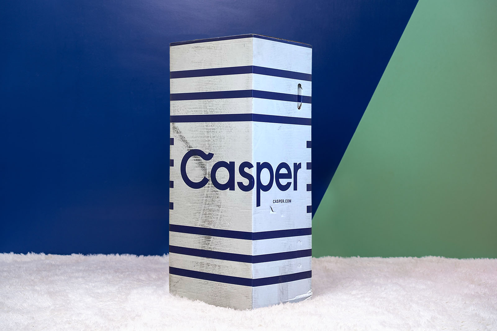 The Casper box upright standing on a carpet